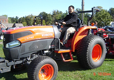 Former Post-doctoral Associate Biao Zhu on a tractor